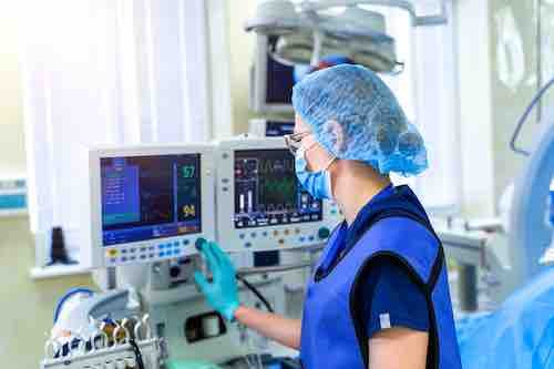 Artificial lung ventilation monitor in the intensive care unit. Nurse with medical equipment. Ventilation of the lungs with oxygen. COVID-19 and coronavirus identification. Pandemic.